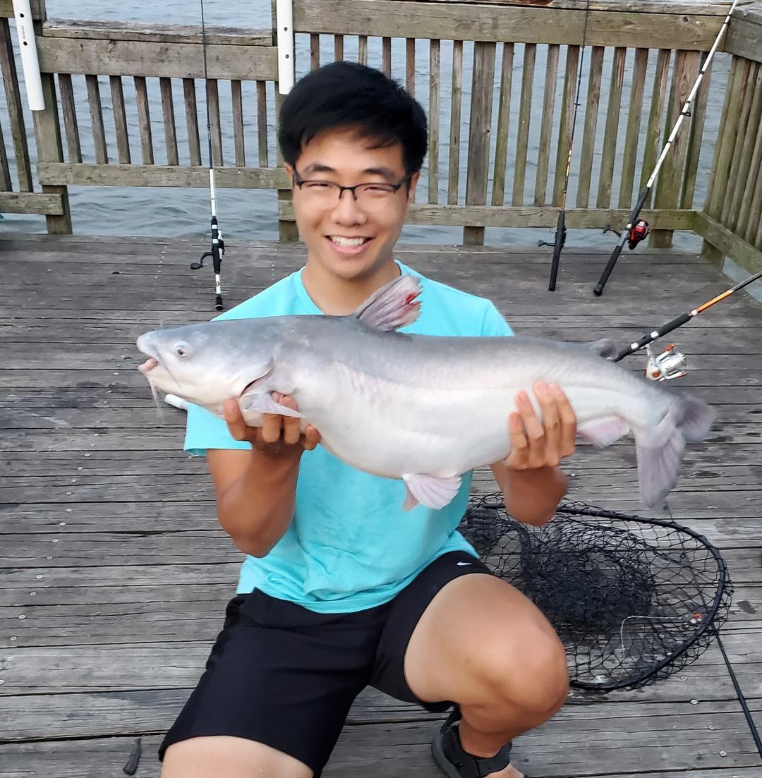 Adriel Kim holding a large catfish